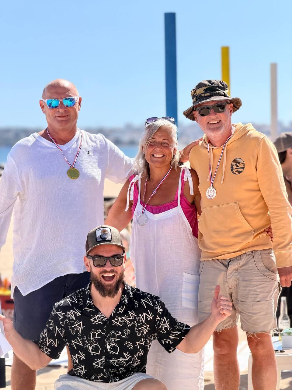 Pirata Beach Bash volunteers and supporters posing together on the beach after the fundraiser