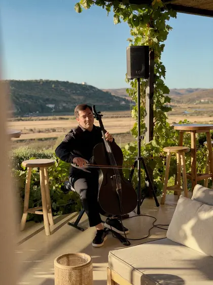 Cellist Júlio Luz performing on the terrace during Vine and Fire.