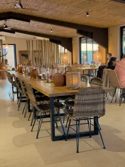 The Vine and Fire dining room filled with guests around the long table.